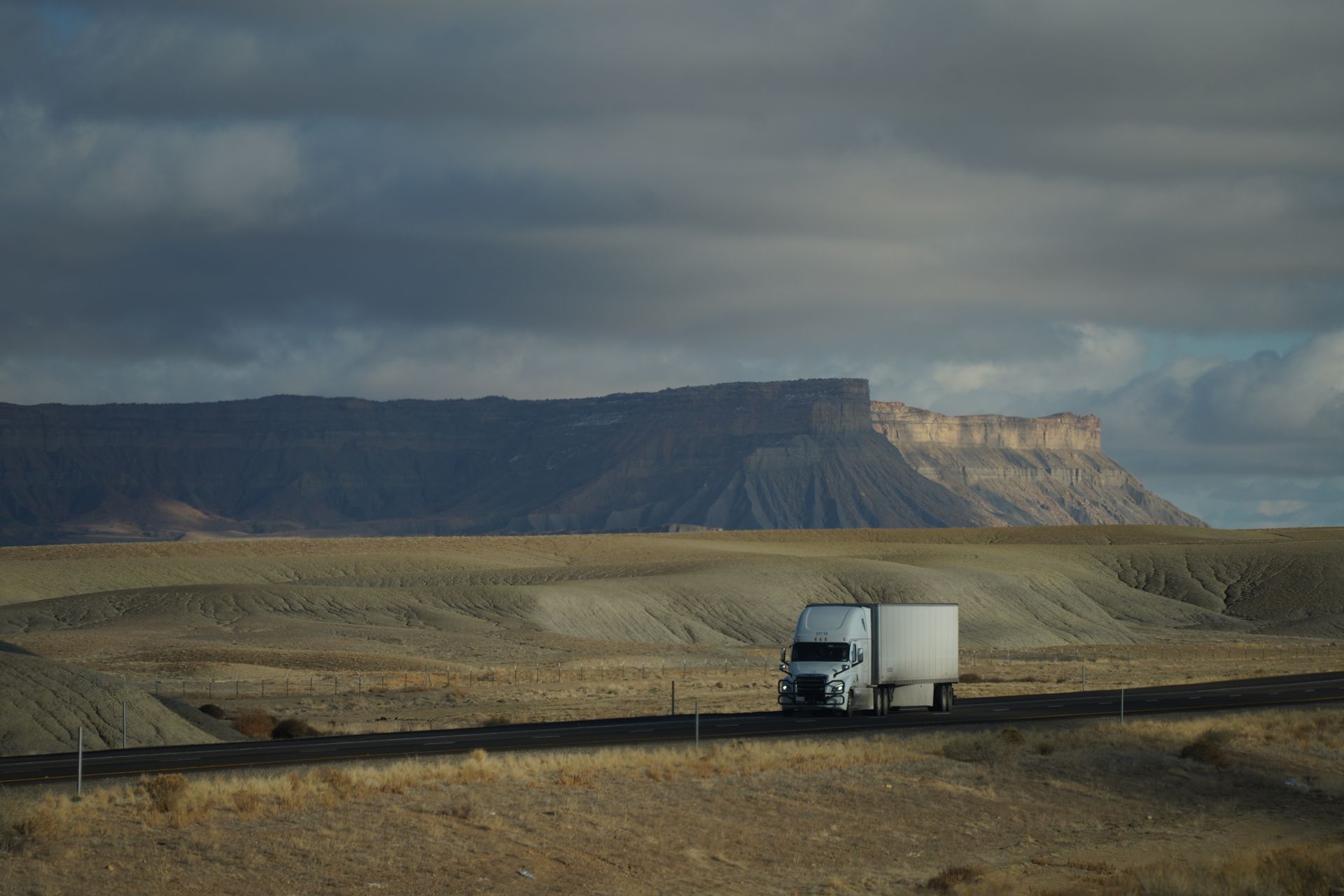 Commercial truck on an open highway at dusk